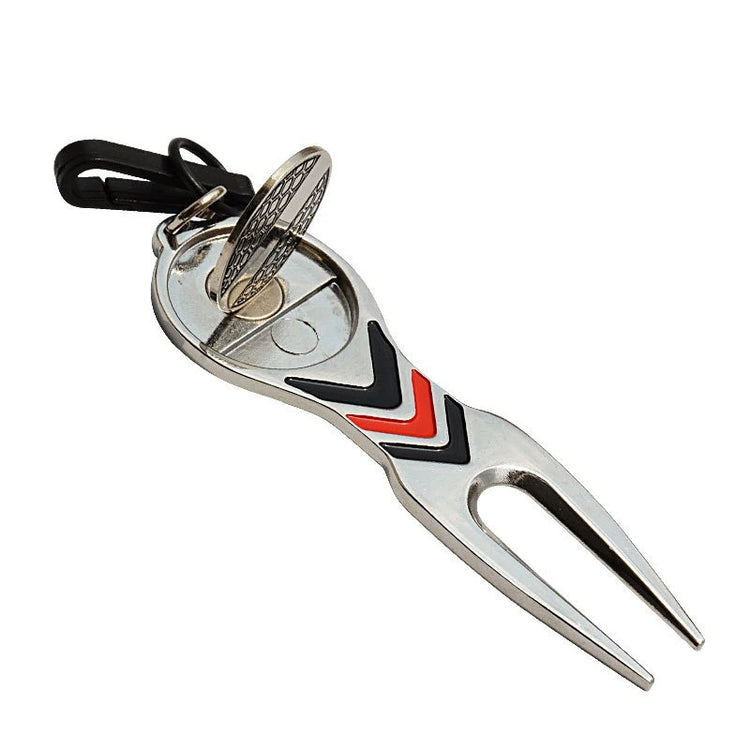 Golf divot repair tool lifting grass on golf course
