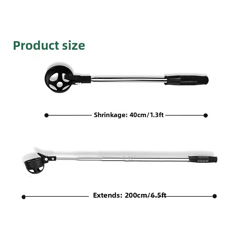 Extendable golf ball retriever tool picking ball from grass on golf course