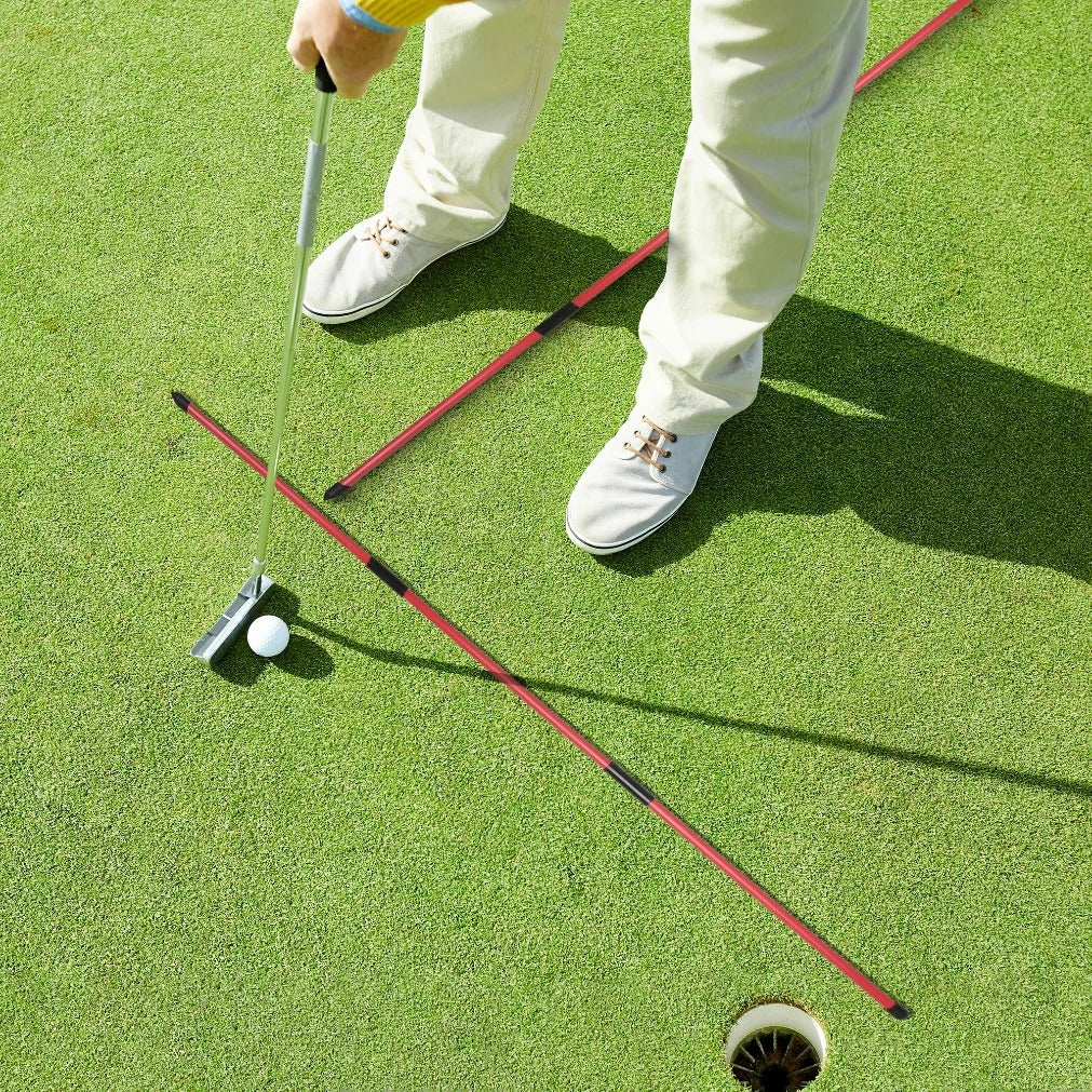 Golf alignment rods showing target line on practice range